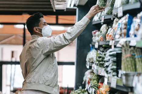 A man wearing a face mask in a grocery store
