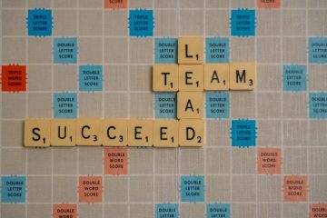 The words succeed, lead, and team, set in a Scrabble board.
