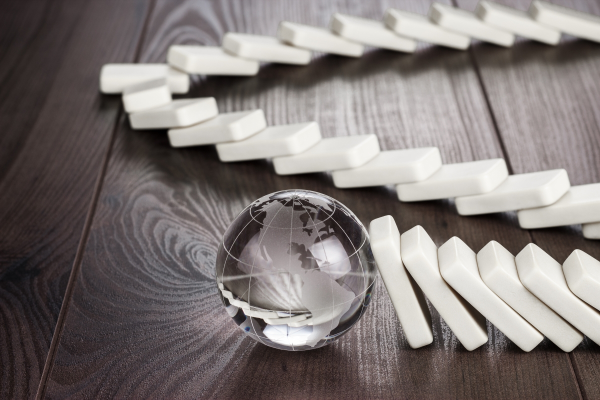 A chain of dominoes knocking into a marble.